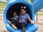 Two children coming out of slide