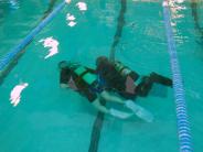 Two people swimming with scuba gear