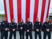 Public Safety Officers in front of American Flag