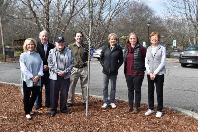 Members of the community appearance advisory commission pose with a tree
