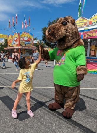 Gus the Groundhog, Festival mascot high fiving child