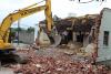 Excavator and demolished building